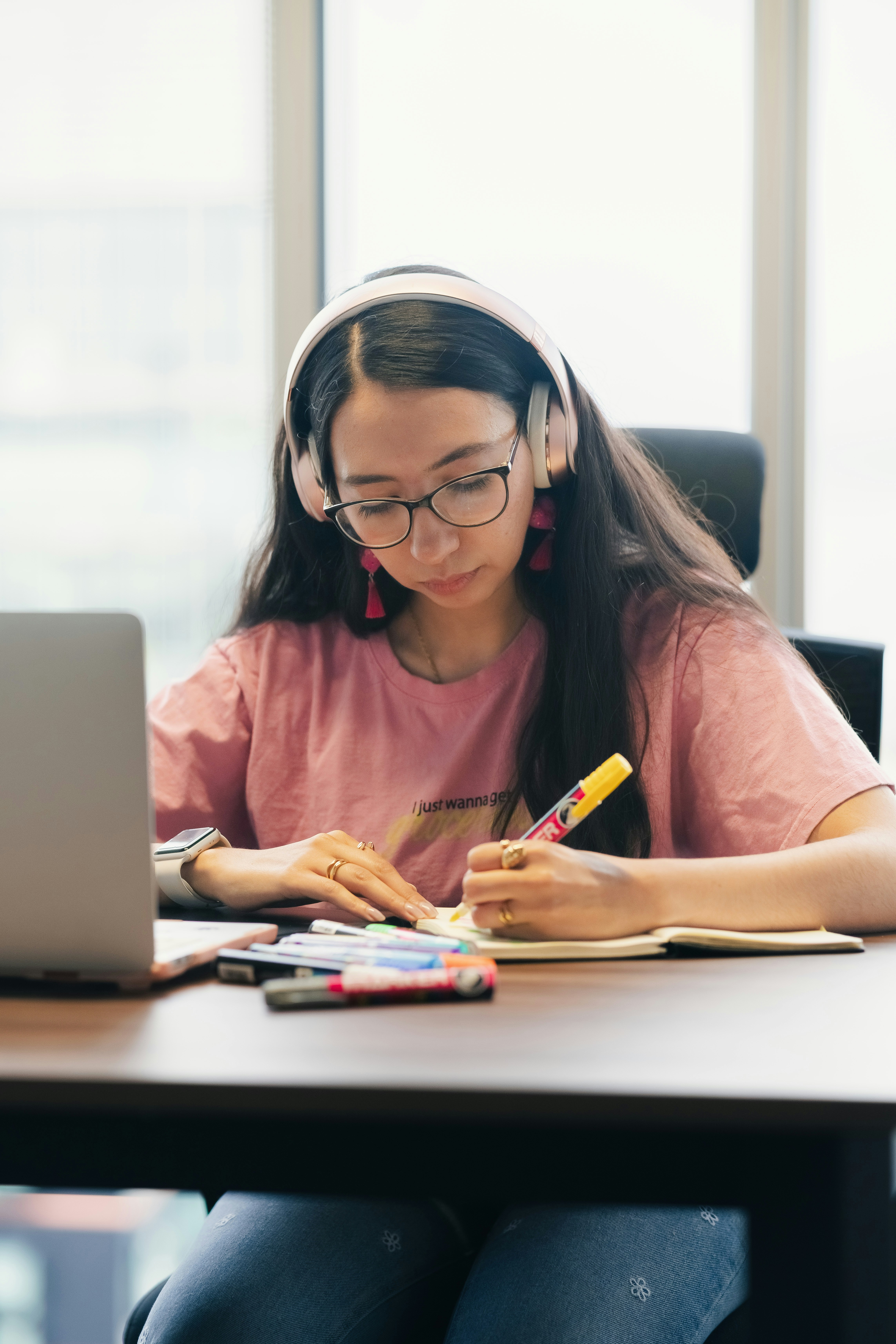 Student studying with a laptop and taking notes